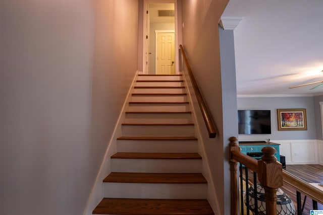 7835 Windsong Dr, Trussville, AL 35173 - stairs with wood finished floors, ornamental molding, ceiling fan, and a wainscoted wall