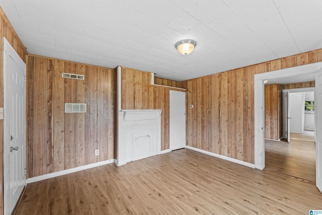 606 W Pine St, Sylacauga, AL 35150 - spare room featuring wooden walls and wood finished floors