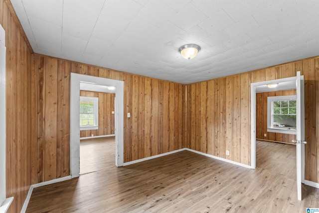 606 W Pine St, Sylacauga, AL 35150 - spare room with light wood-style floors and wood walls