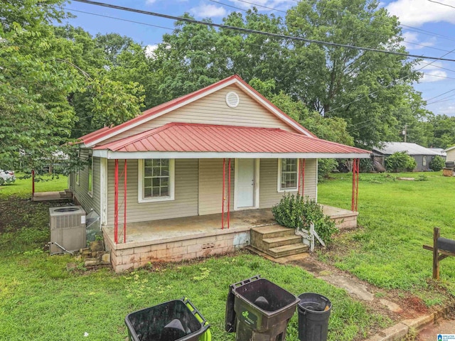 606 W Pine St, Sylacauga, AL 35150 - view of front of house featuring a front yard, covered porch, and a metal roof
