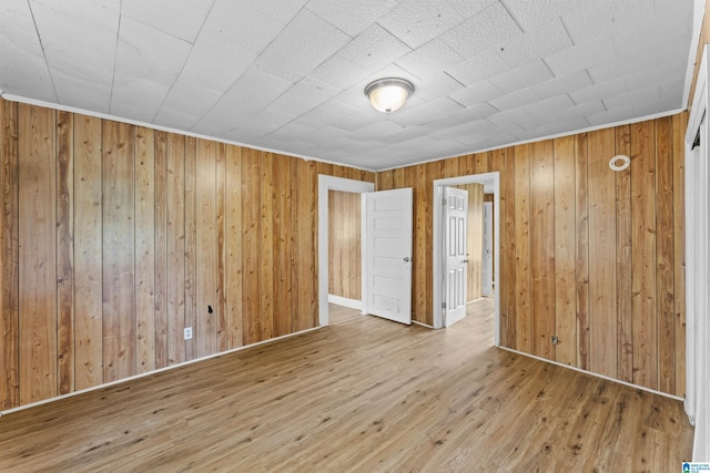 606 W Pine St, Sylacauga, AL 35150 - spare room featuring wood-type flooring and wooden walls
