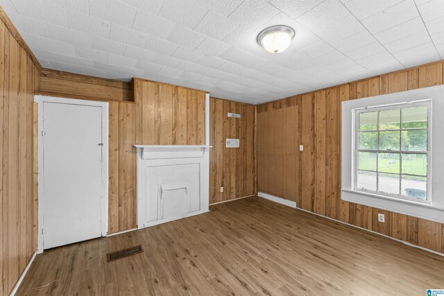 606 W Pine St, Sylacauga, AL 35150 - spare room featuring wood finished floors and wooden walls