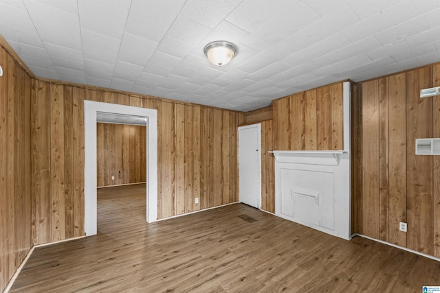 606 W Pine St, Sylacauga, AL 35150 - spare room featuring wooden walls and wood finished floors