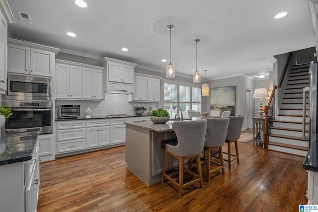 2000 Regency Way, Birmingham, AL 35242 - kitchen featuring appliances with stainless steel finishes, crown molding, white cabinetry, decorative backsplash, and dark wood-style flooring