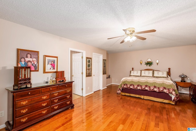 20571 Faynell Cir, Woodstock, AL 35188 - bedroom featuring light wood-style floors, ceiling fan, and a textured ceiling