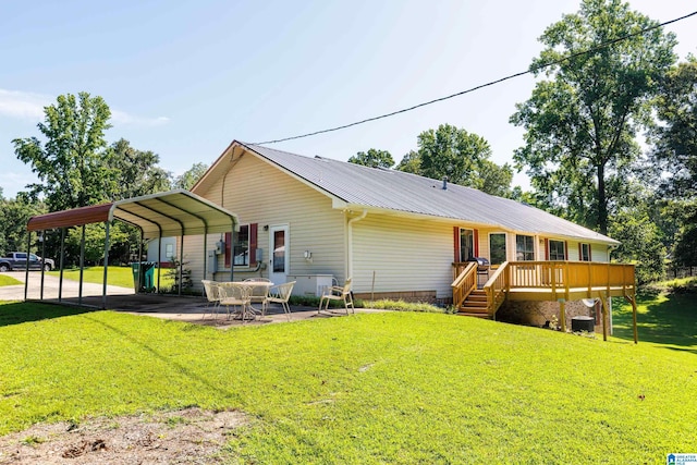 20571 Faynell Cir, Woodstock, AL 35188 - back of house featuring a lawn, a carport, a wooden deck, and a metal roof