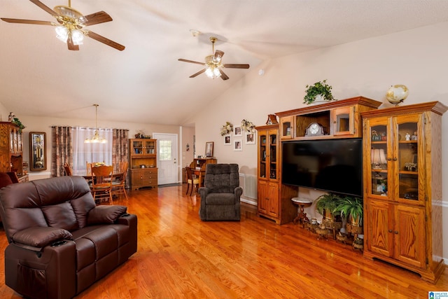 20571 Faynell Cir, Woodstock, AL 35188 - living area with ceiling fan, light wood finished floors, vaulted ceiling, and a chandelier