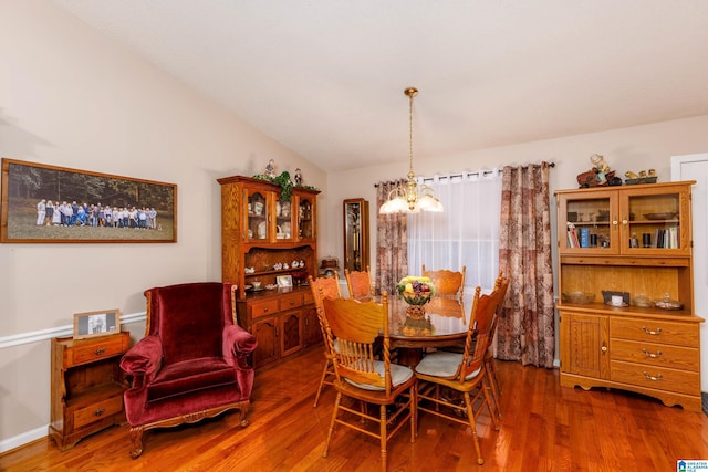 20571 Faynell Cir, Woodstock, AL 35188 - dining area with a chandelier, vaulted ceiling, and wood finished floors