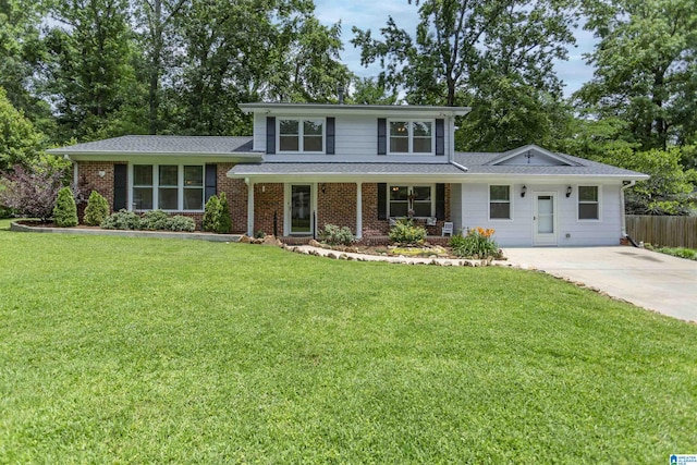 2205 Blue Ridge Blvd, Hoover, AL 35226 - split level home featuring concrete driveway, brick siding, covered porch, and view of wooded area