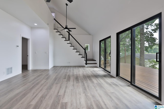 442 Lakeview Cir, Alpine, AL 35014 - unfurnished living room with ceiling fan, plenty of natural light, stairs, high vaulted ceiling, and light wood-style flooring