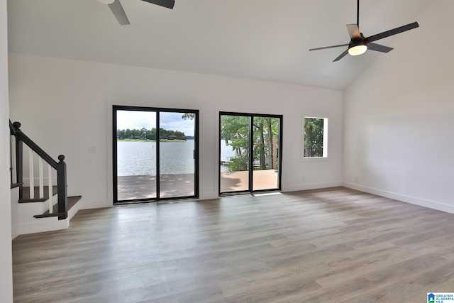 442 Lakeview Cir, Alpine, AL 35014 - unfurnished living room with a ceiling fan, high vaulted ceiling, light wood-type flooring, stairs, and a water view