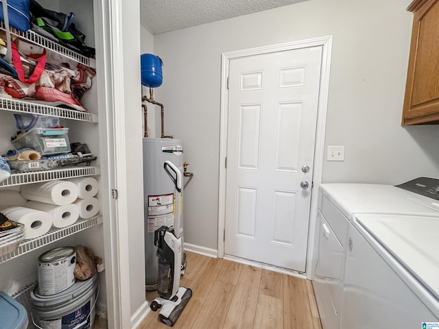 489 Bailey Loop Rd, Gardendale, AL 35071 - laundry area featuring cabinet space, water heater, light wood-style floors, independent washer and dryer, and a textured ceiling