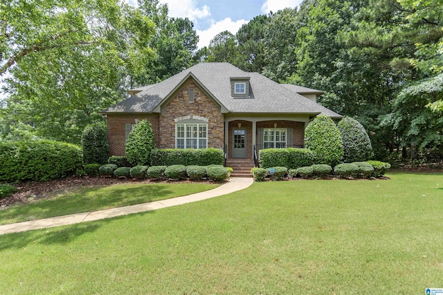 5668 Carrington Lake Pkwy, Trussville, AL 35173 - view of front of home with stone siding, a front lawn, brick siding, and a shingled roof