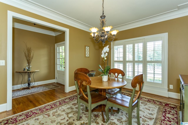 5668 Carrington Lake Pkwy, Trussville, AL 35173 - dining space with a chandelier, plenty of natural light, wood finished floors, and ornamental molding