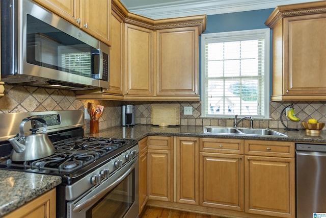 5668 Carrington Lake Pkwy, Trussville, AL 35173 - kitchen featuring appliances with stainless steel finishes, backsplash, crown molding, brown cabinets, and dark stone countertops