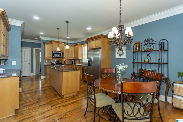 5668 Carrington Lake Pkwy, Trussville, AL 35173 - dining room featuring a chandelier, wood finished floors, ornamental molding, and recessed lighting