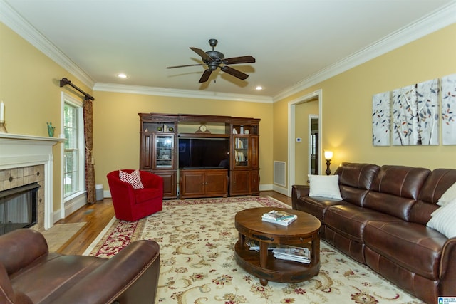 5668 Carrington Lake Pkwy, Trussville, AL 35173 - living area with a ceiling fan, crown molding, wood finished floors, a tile fireplace, and recessed lighting