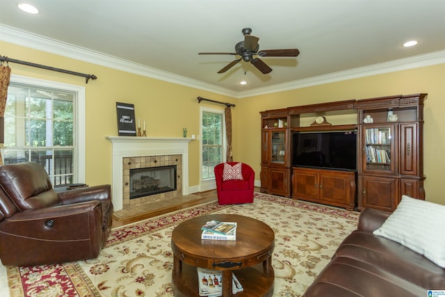 5668 Carrington Lake Pkwy, Trussville, AL 35173 - living room featuring plenty of natural light, ceiling fan, ornamental molding, a tile fireplace, and wood finished floors