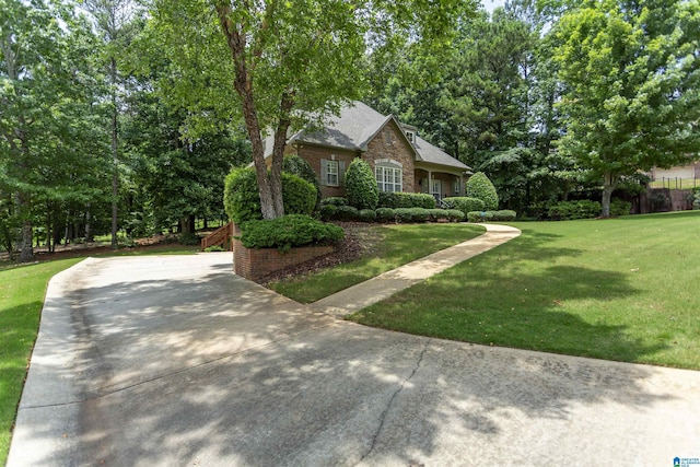 5668 Carrington Lake Pkwy, Trussville, AL 35173 - view of front of house featuring a front yard, concrete driveway, and brick siding
