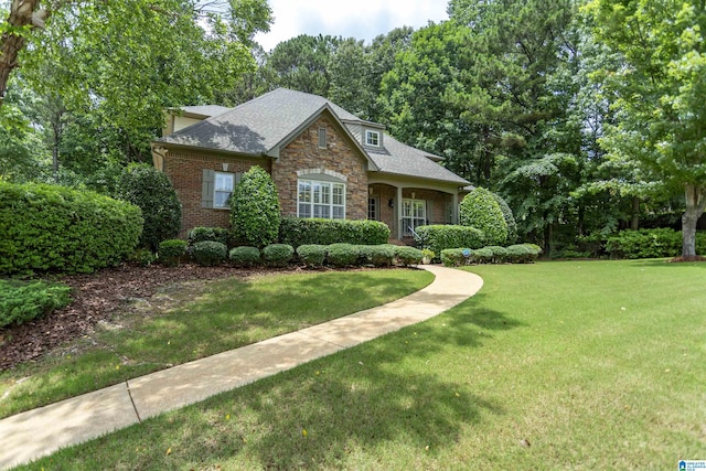5668 Carrington Lake Pkwy, Trussville, AL 35173 - view of front of house featuring a front lawn, stone siding, brick siding, and a shingled roof