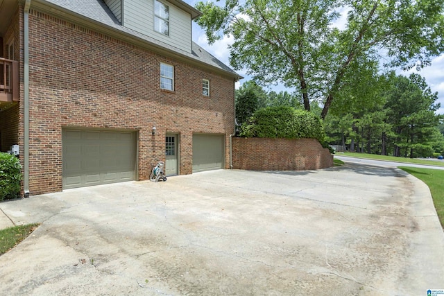 5668 Carrington Lake Pkwy, Trussville, AL 35173 - view of home's exterior featuring brick siding, an attached garage, and concrete driveway