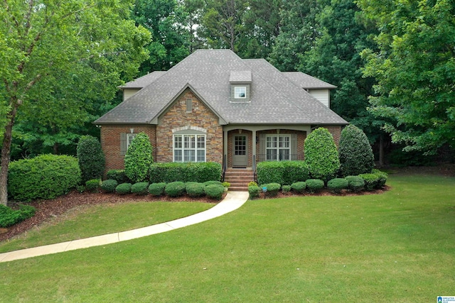 5668 Carrington Lake Pkwy, Trussville, AL 35173 - view of front of home with a front yard, roof with shingles, and brick siding