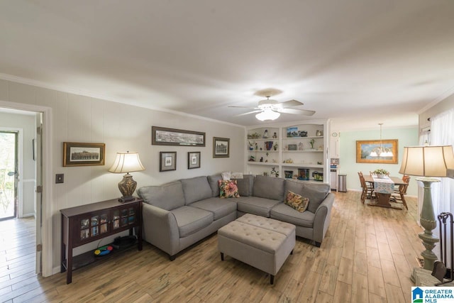 1912 Tall Timbers Dr, Hoover, AL 35226 - living room featuring ornamental molding, light wood-style flooring, ceiling fan, and a chandelier