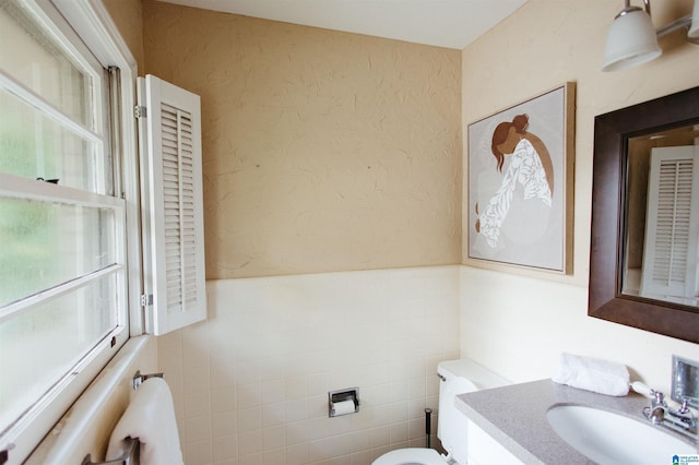 4648 Clairmont Ave S, Birmingham, AL 35222 - half bath with vanity, wainscoting, tile walls, and a textured wall