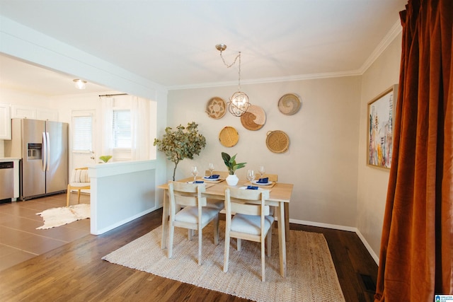 4648 Clairmont Ave S, Birmingham, AL 35222 - dining area featuring crown molding, wood finished floors, and a chandelier