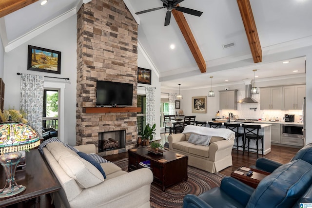 715 W Cassie Dr, Pell City, AL 35128 - living area with a ceiling fan, high vaulted ceiling, dark wood-style flooring, a fireplace, and beamed ceiling