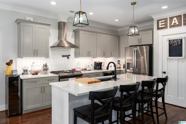 715 W Cassie Dr, Pell City, AL 35128 - kitchen featuring appliances with stainless steel finishes, gray cabinetry, wall chimney range hood, beverage cooler, and light countertops