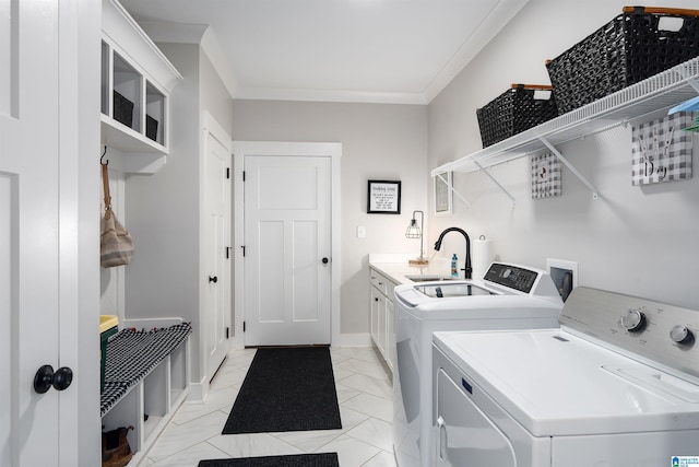 715 W Cassie Dr, Pell City, AL 35128 - laundry area featuring cabinet space, washing machine and clothes dryer, crown molding, and light marble finish floors