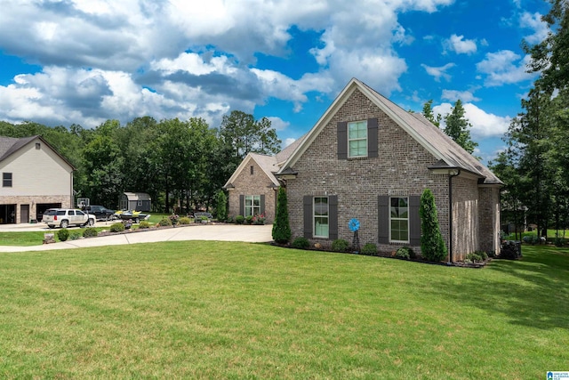 715 W Cassie Dr, Pell City, AL 35128 - view of front of home featuring brick siding, a front yard, and driveway