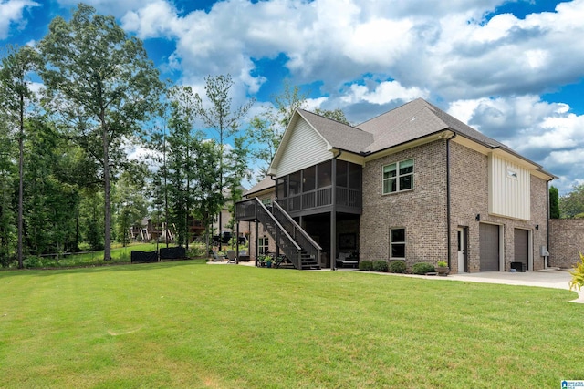 715 W Cassie Dr, Pell City, AL 35128 - back of property with a sunroom, a garage, stairway, brick siding, and concrete driveway