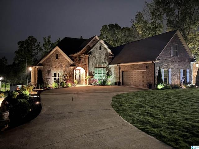 715 W Cassie Dr, Pell City, AL 35128 - view of front of property featuring driveway, a garage, brick siding, and a lawn