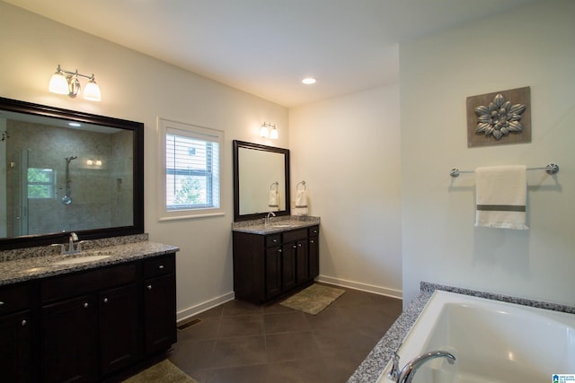 5250 Kate Cv, Trussville, AL 35173 - bathroom featuring two vanities, tile patterned floors, a shower stall, and a bath