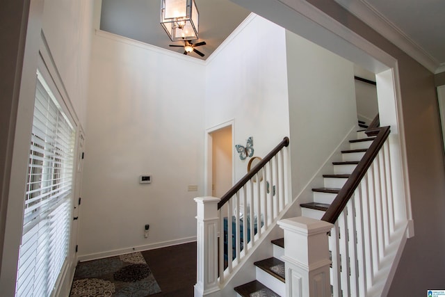 5250 Kate Cv, Trussville, AL 35173 - staircase featuring crown molding, a towering ceiling, and wood finished floors