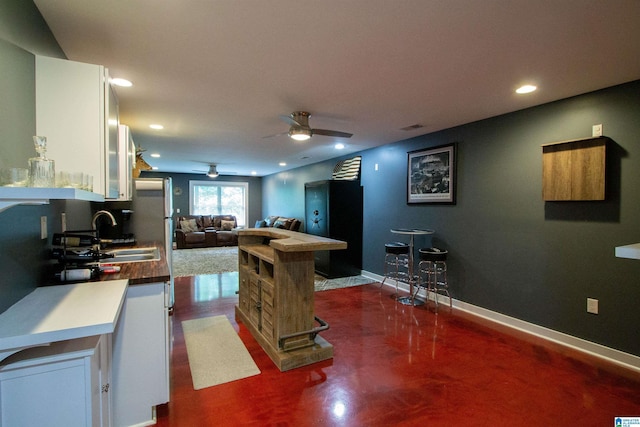 5250 Kate Cv, Trussville, AL 35173 - kitchen featuring white cabinetry, ceiling fan, recessed lighting, freestanding refrigerator, and open floor plan
