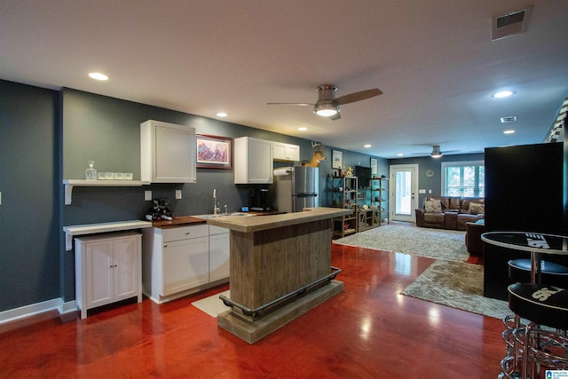 5250 Kate Cv, Trussville, AL 35173 - kitchen featuring ceiling fan, white cabinetry, a kitchen island, recessed lighting, and freestanding refrigerator
