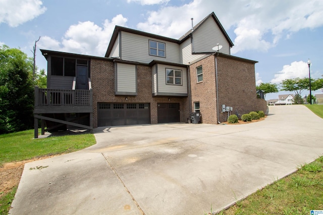 5250 Kate Cv, Trussville, AL 35173 - rear view of house with an attached garage, brick siding, and concrete driveway