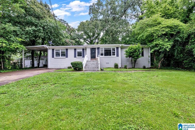 1821 4th St NW, Center Point, AL 35215 - ranch-style house with driveway, an attached carport, and a front lawn