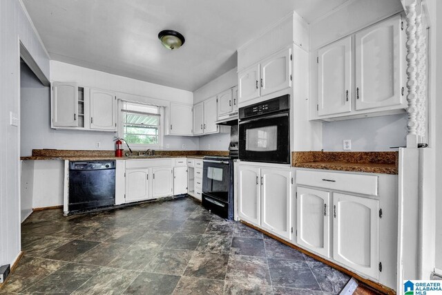 1821 4th St NW, Center Point, AL 35215 - kitchen with black appliances, dark countertops, white cabinets, stone finish floors, and under cabinet range hood