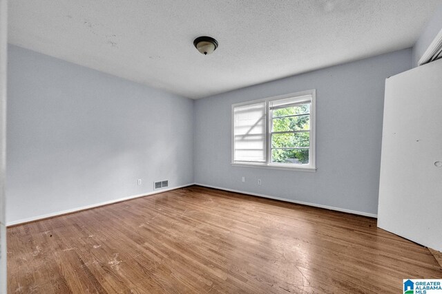 1821 4th St NW, Center Point, AL 35215 - unfurnished room with wood finished floors and a textured ceiling