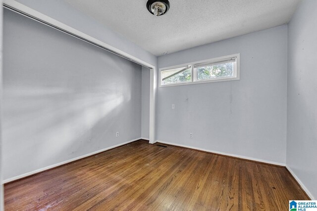 1821 4th St NW, Center Point, AL 35215 - spare room with hardwood / wood-style flooring and a textured ceiling
