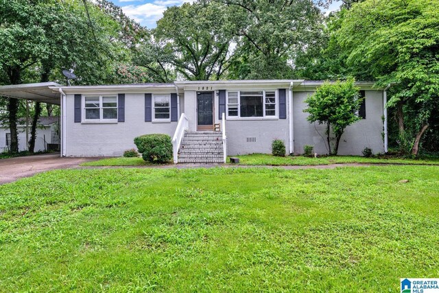 1821 4th St NW, Center Point, AL 35215 - single story home with brick siding, an attached carport, a front yard, and driveway