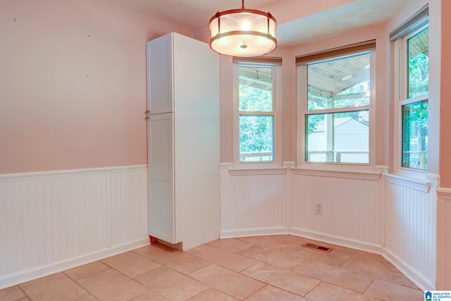 204 Shalimar Cir, Alabaster, AL 35007 - unfurnished dining area featuring a wainscoted wall and light tile patterned floors