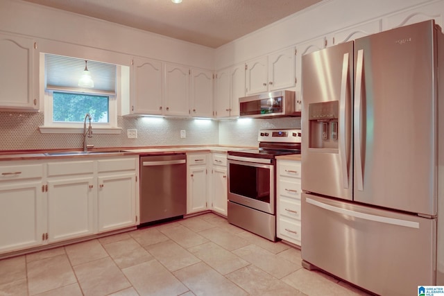204 Shalimar Cir, Alabaster, AL 35007 - kitchen with appliances with stainless steel finishes, tasteful backsplash, white cabinets, light countertops, and light tile patterned floors