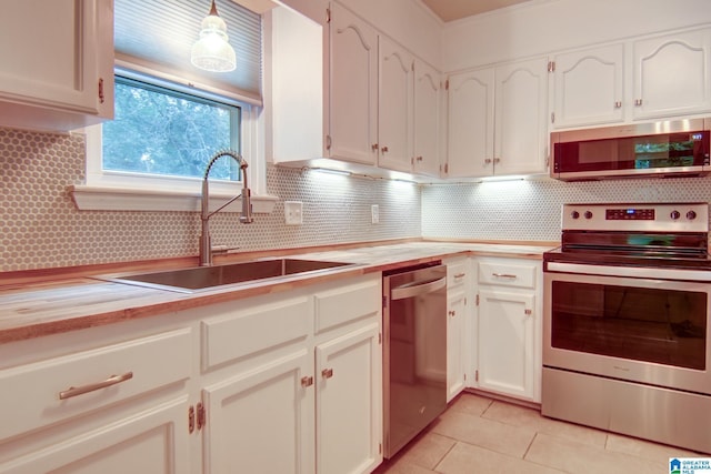 204 Shalimar Cir, Alabaster, AL 35007 - kitchen featuring appliances with stainless steel finishes, white cabinetry, and tasteful backsplash