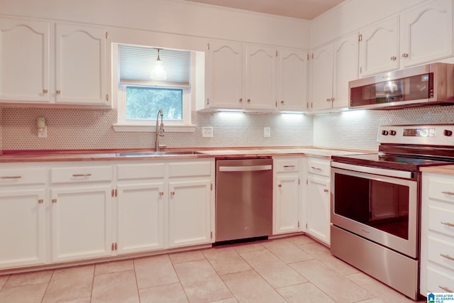 204 Shalimar Cir, Alabaster, AL 35007 - kitchen with appliances with stainless steel finishes, decorative backsplash, and white cabinetry