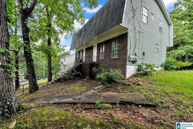 1722 6th Place Cir NW, Center Point, AL 35215 - view of property exterior featuring brick siding, roof with shingles, and stairs
